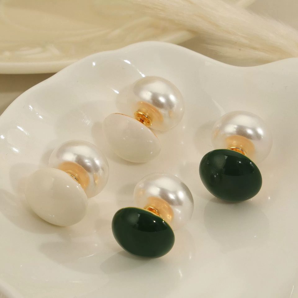Gold-Tone Vintage Enamel Pearl Drop Earrings with White and Green Details on Fabric