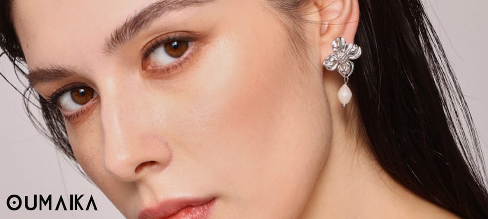 Minimalist gold star earrings on white background
