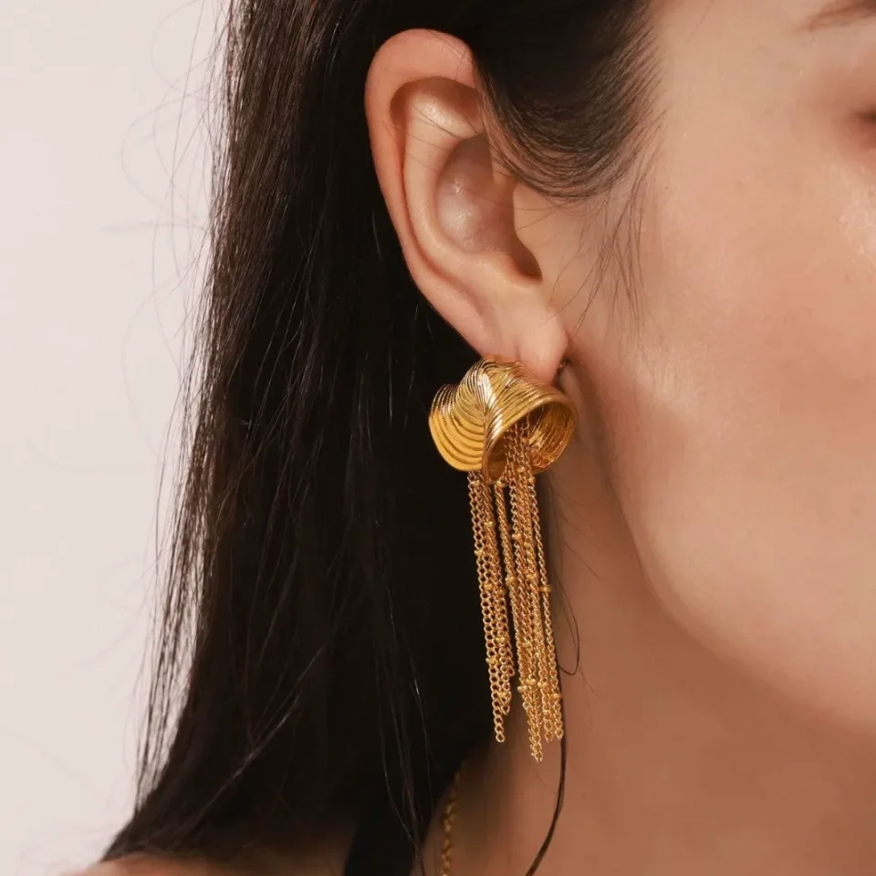 Model Wearing OUDADA F1453 Gold Spiral Shell Tassel Earrings - Luxurious & Eye-Catching
