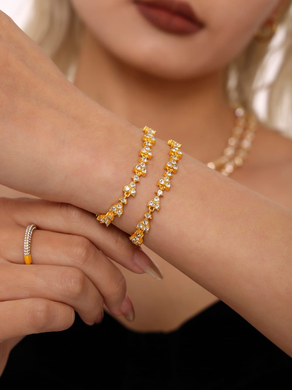Model wearing TXE215 white zircon bracelet in gold tone.