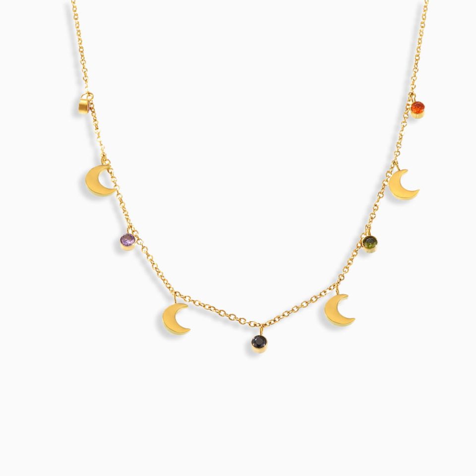 Colorful moon tassel necklace with rhinestone accents on white background