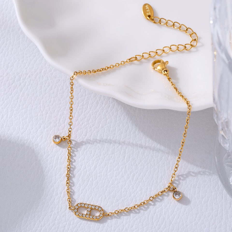 Eternal Radiance 18K gold-plated stainless steel cubic zirconia tennis anklet on sandy beach