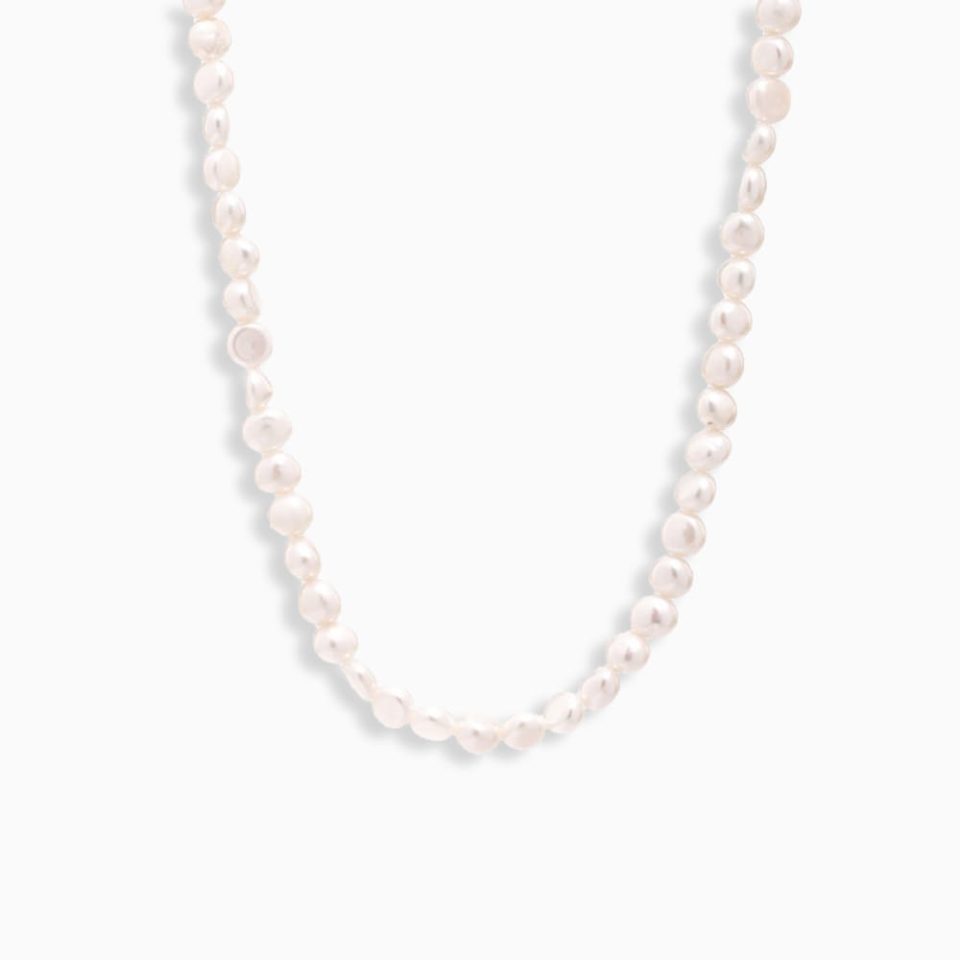 Freshwater pearl choker necklace with minimalist gold pendant on white background