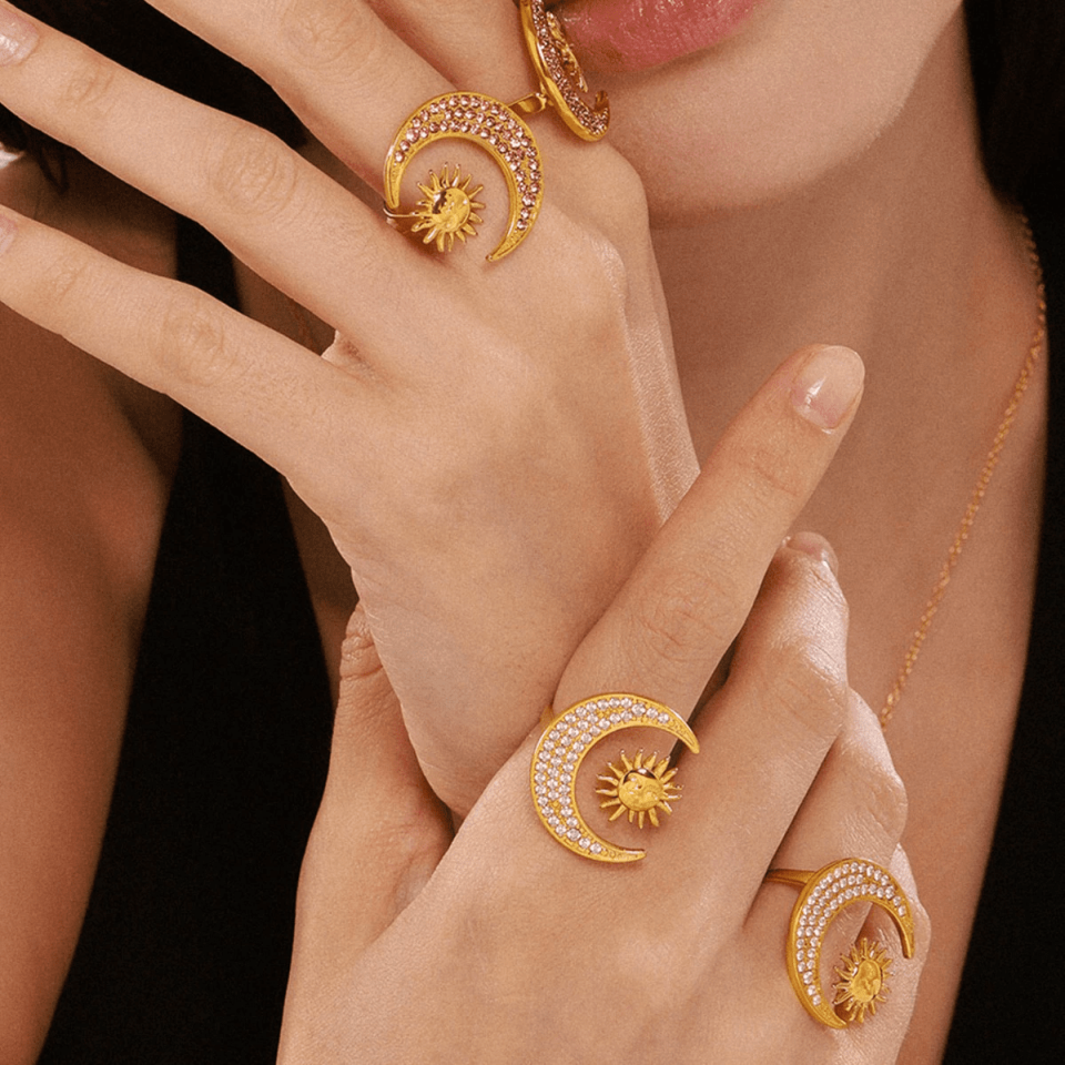 Model wearing steel sun and moon jewelry under ambient evening lighting, showcasing zirconia's dual-color effect