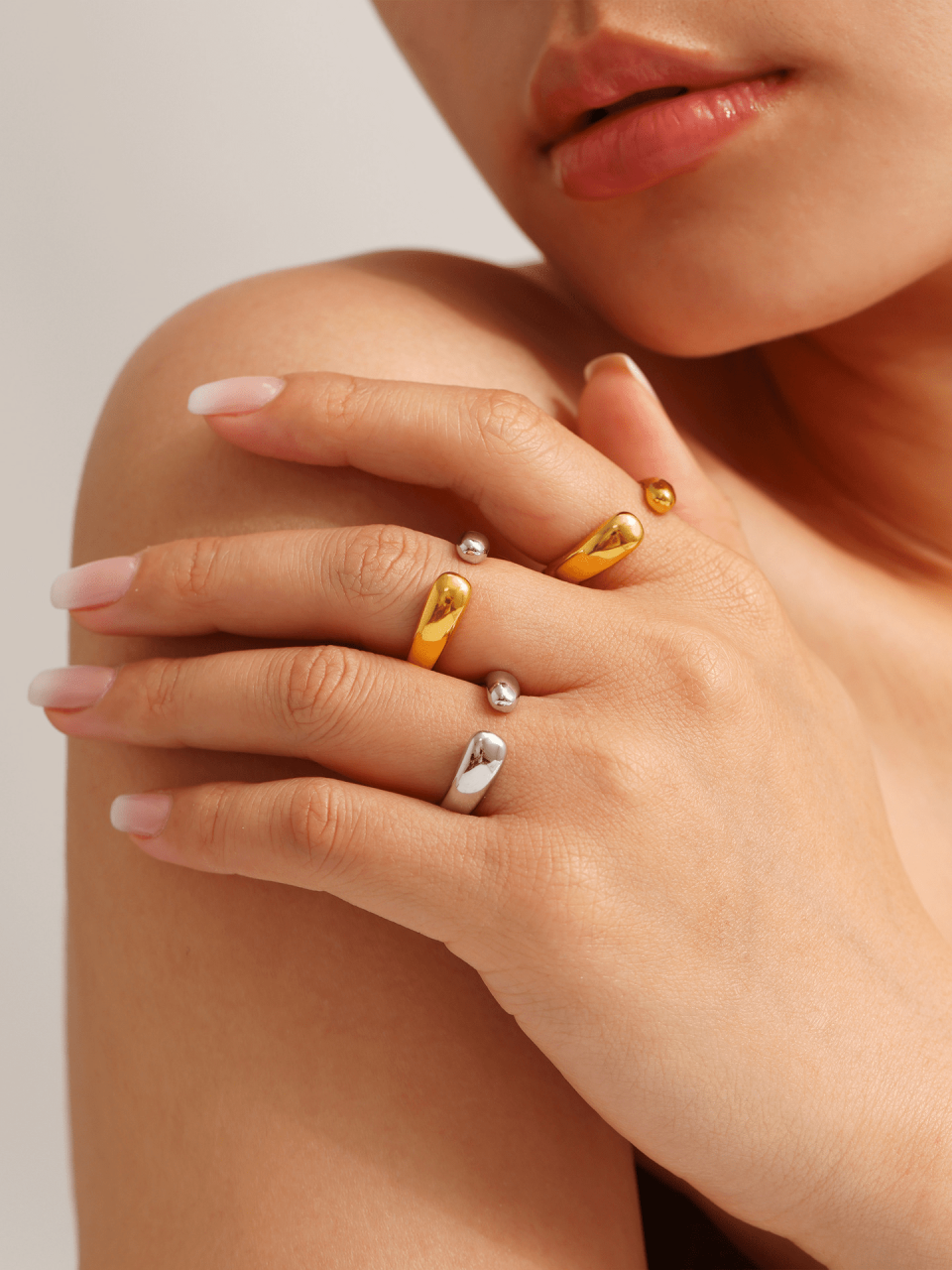 Model wearing mixed metal open arc rings - Oudada's unisex minimalist collection