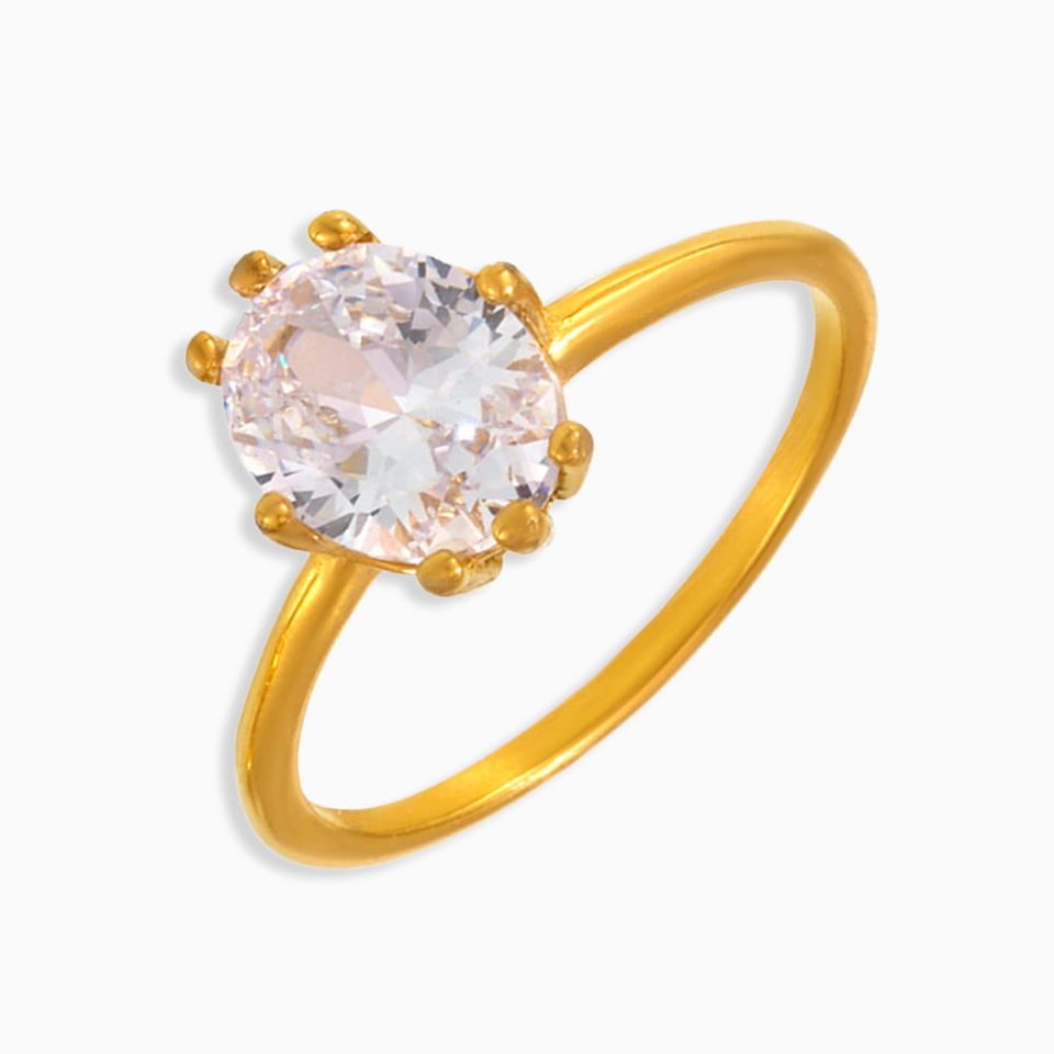 Oval cut cubic zirconia ring on white background, gold stainless steel band designed for daily wear