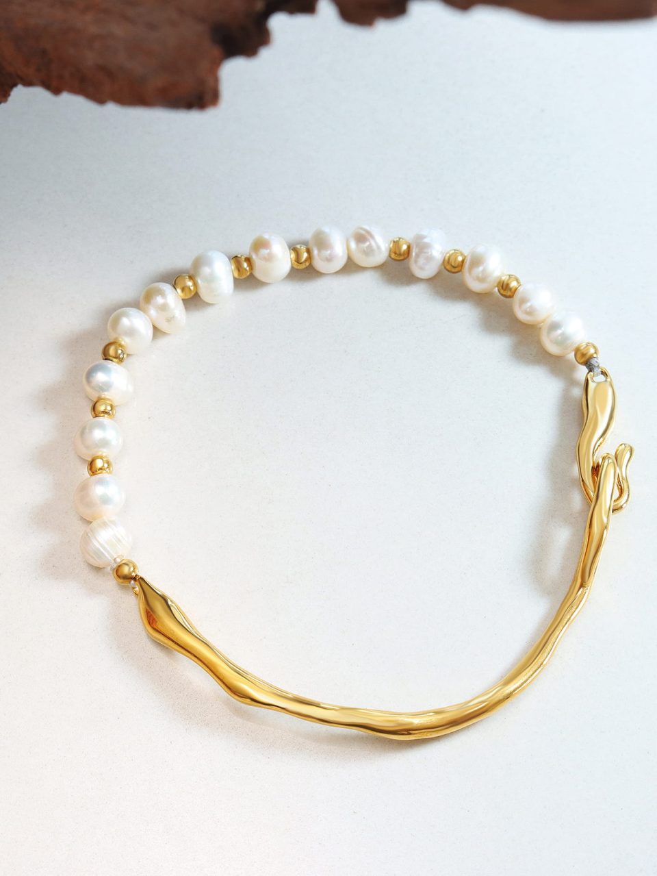 A Ivory Grace Cuff bracelet displayed in a stylish setting, showcasing its elegant design and craftsmanship.