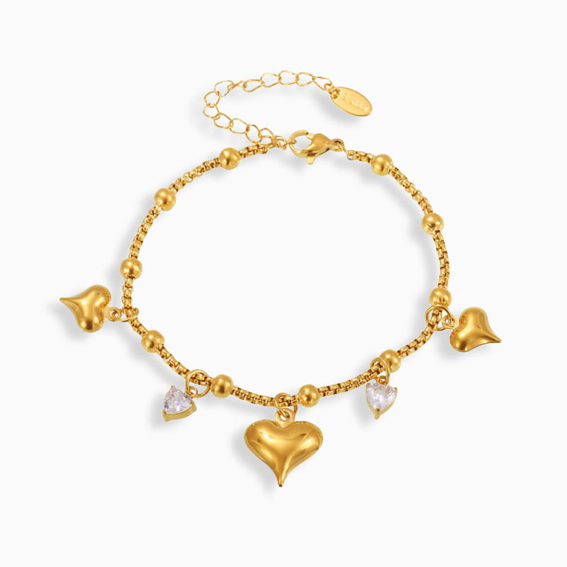 Designer Inspired Heart Charm Bracelet in 18K gold plated stainless steel with cubic zirconia and heart charms, shown on a white background