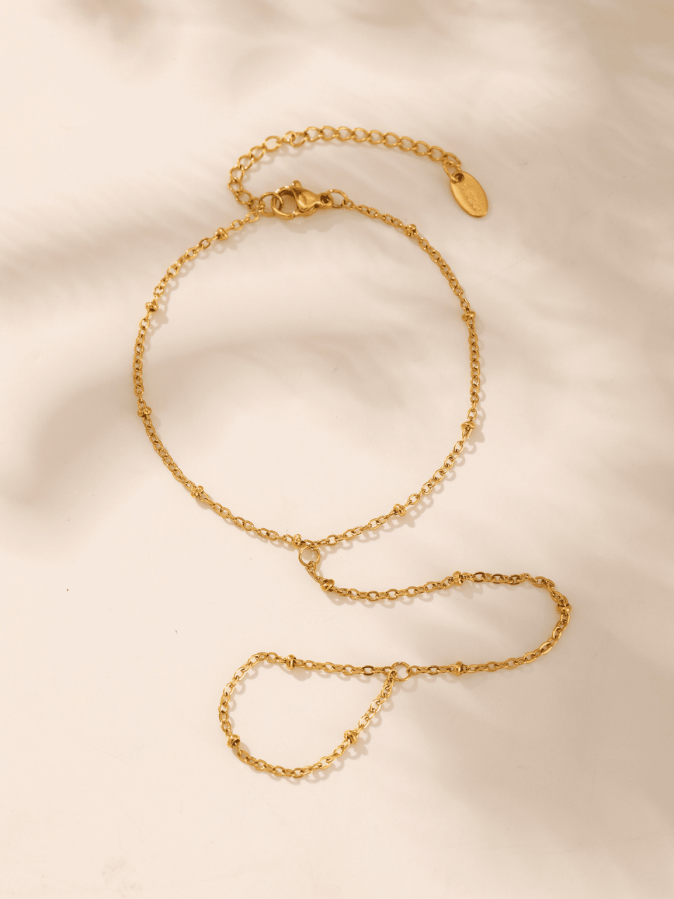 E597 gold millet bead chain styled with dried flowers and linen - boho jewelry flat lay