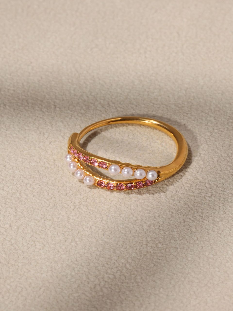 gold adjustable statement ring with pink pearls and cubic zirconia in a lifestyle setting