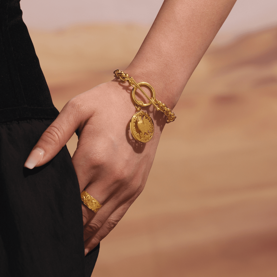 Model with hand in pocket, wearing E598 Gold OT Clasp Bracelet 16+4cm, showcasing casual style.