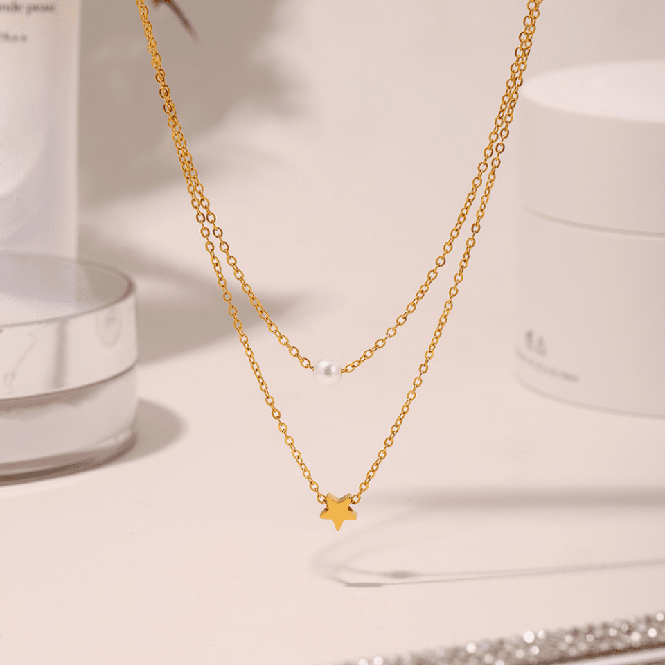 Close-up angled/macro views of Oudada's celestial bead necklace - titanium steel chain with star-inspired pearls