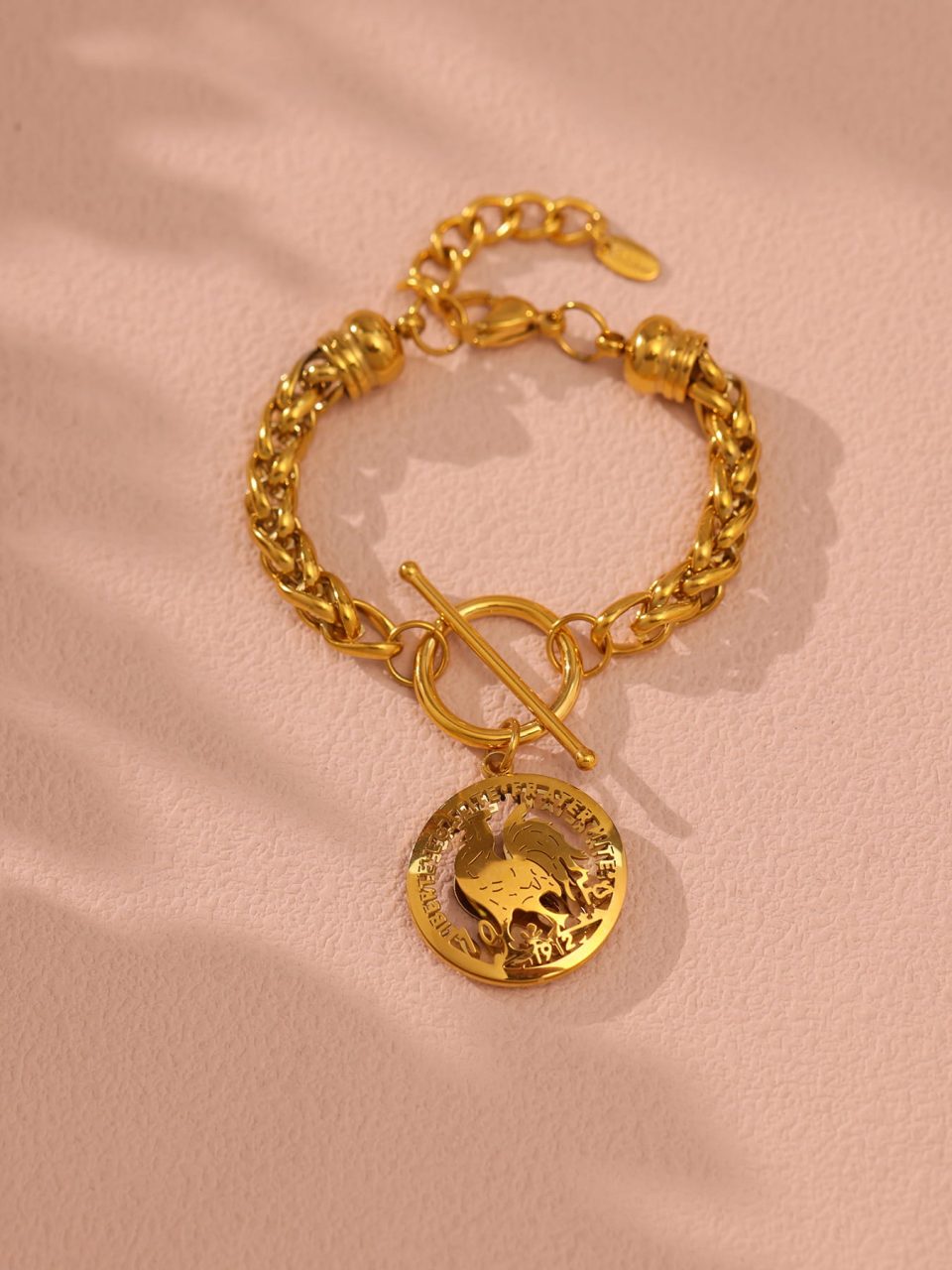 E598 Gold OT Clasp Bracelet 16+4cm displayed in a warm-toned scene.