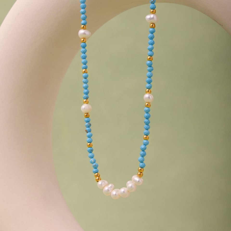 A warm-toned scene featuring the TXP229 turquoise and pearl necklace, creating a cozy and inviting atmosphere.