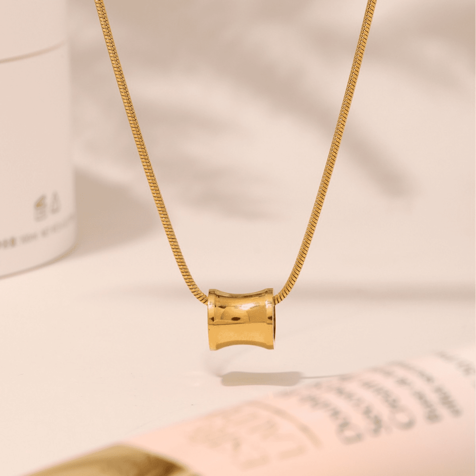 Flat lay of Oudada gold minimalist necklace on white background - 40+5cm stainless steel chain