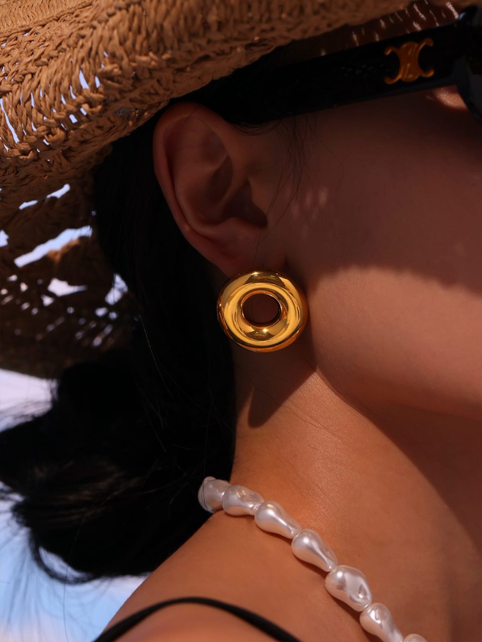 Close-Up of F1383 Gold Hoop Earring on Model - Sunlit Detail of Hollow Circle Design