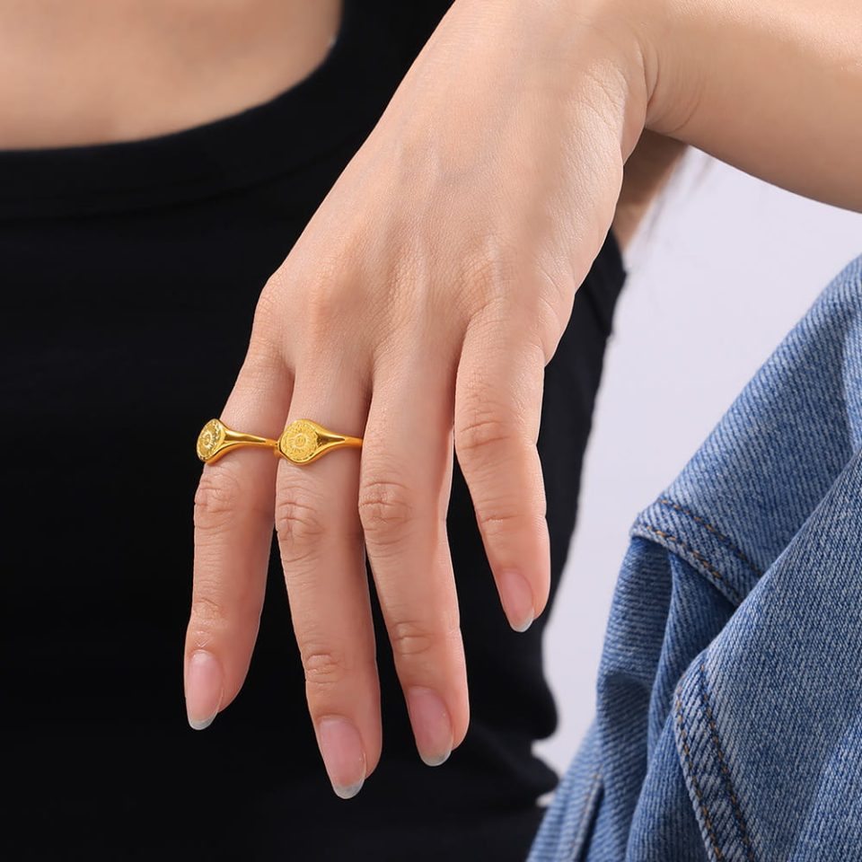 Model wearing Solar Bloom gold statement ring in a minimal outfit