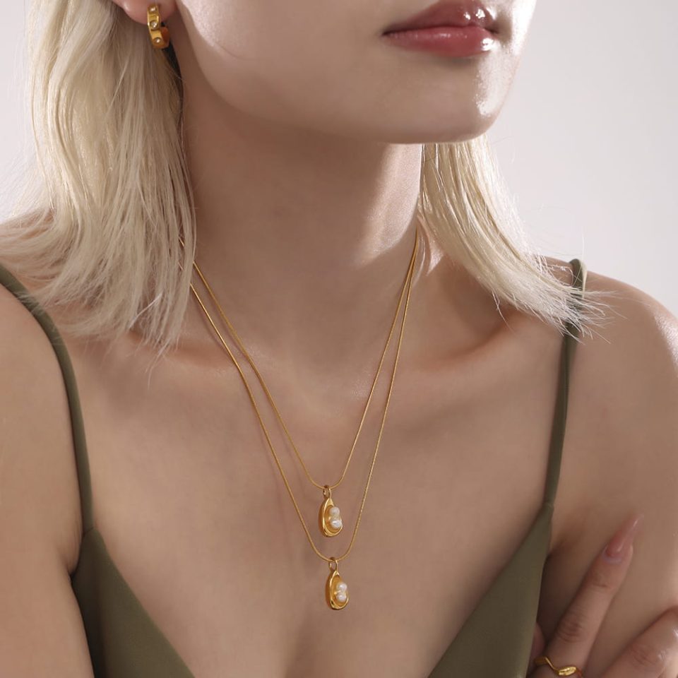 Gold freshwater pearl charm necklace styled on model, 40+5cm adjustable chain