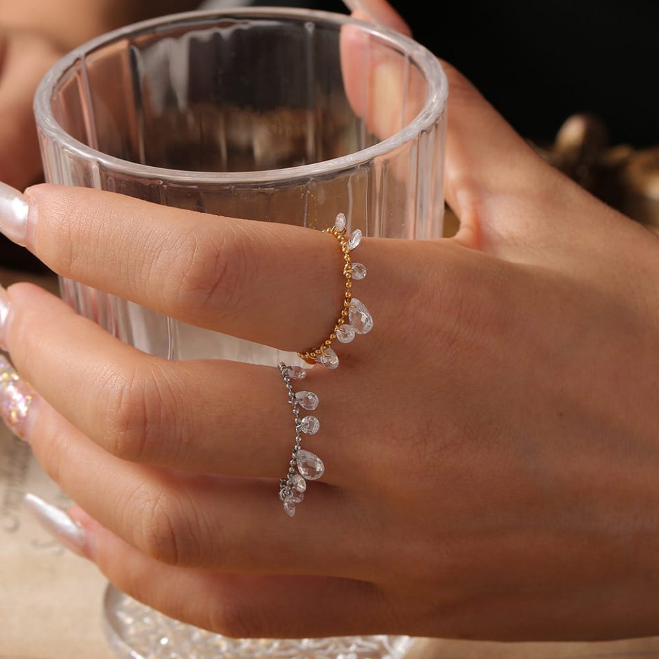 Stack of gold and stainless steel minimalist beaded statement rings worn together