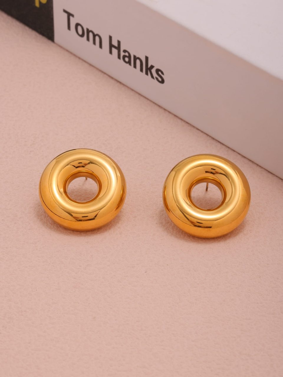Scenic view of gold hoop earrings in everyday setting - F1383