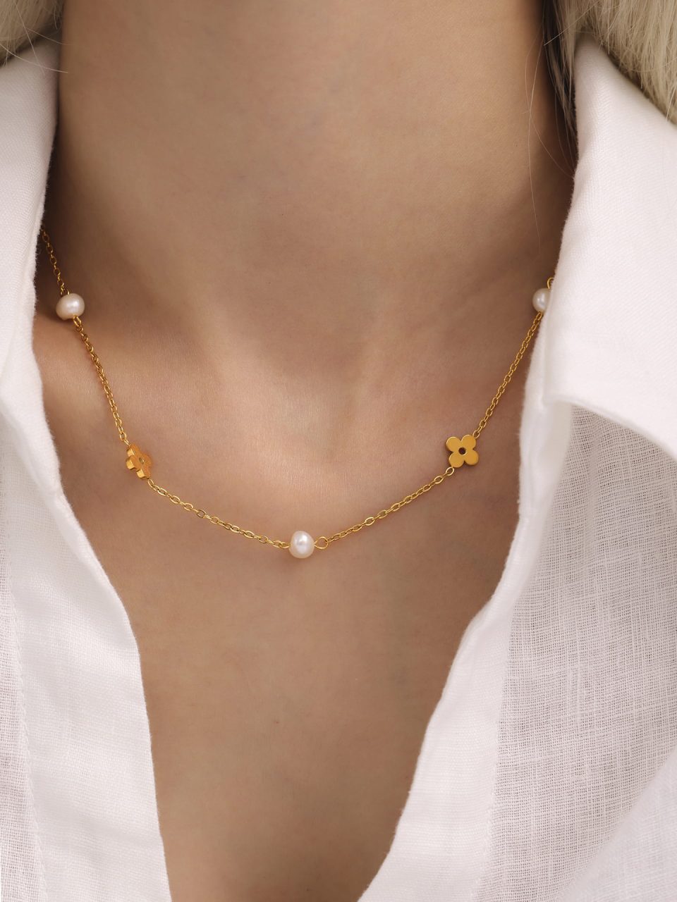 Close‑up on model’s neck showcasing the pearl floral choker necklace detail