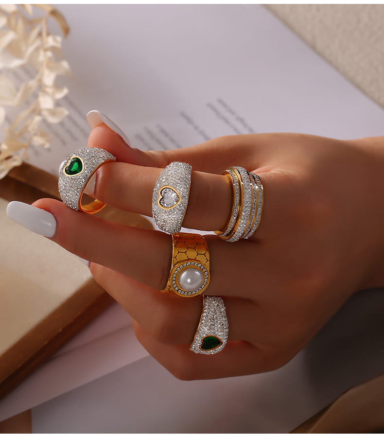 Gold statement ring A826 styled in a stack with other coordinating rings on a model's hand.