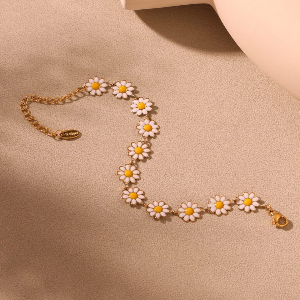 Flat lay of gold daisy flower anklet showing chain length, clasp, and floral charm