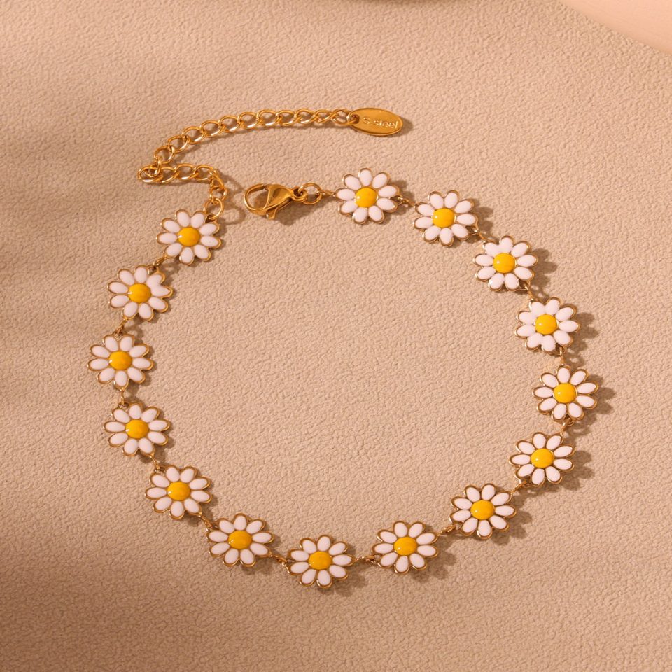 Delicate 18K gold-plated daisy flower anklet worn on ankle, perfect for permanent jewelry lovers