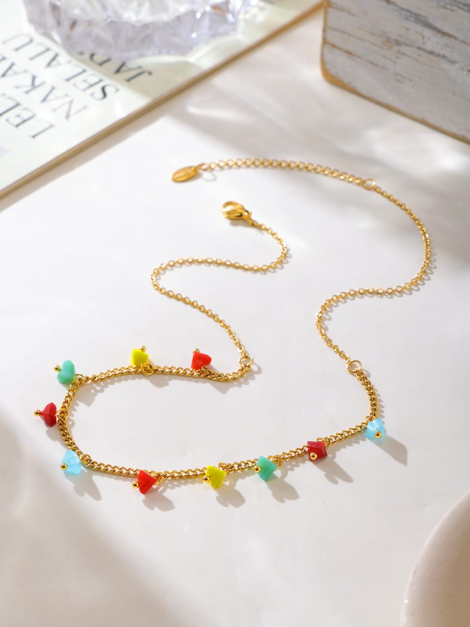 Women’s boho faceted crystal choker necklace styled with warm lighting on wooden table