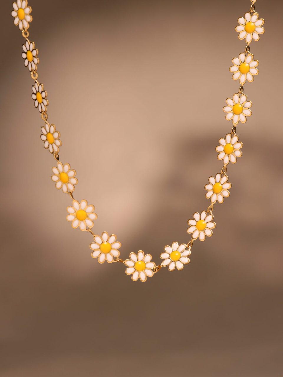 Styled scene showing the Women’s Daisy Oil‑Drop Choker Necklace (33+6 cm) in warm lighting