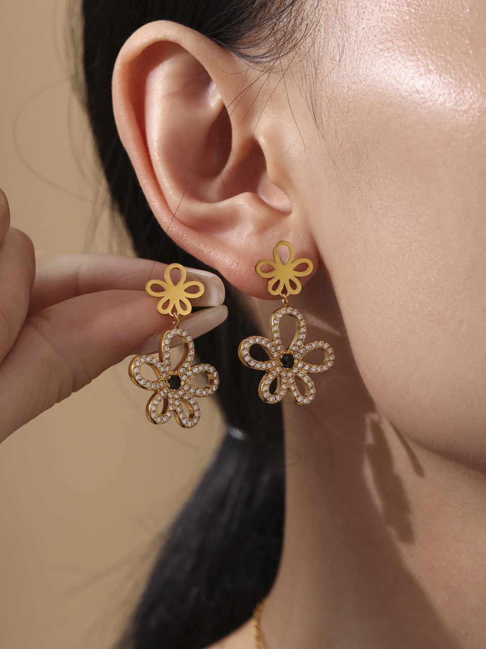 Model Wearing Black Onyx Cubic Zirconia Earrings in Gold Stainless Steel Layered with Other Jewelry