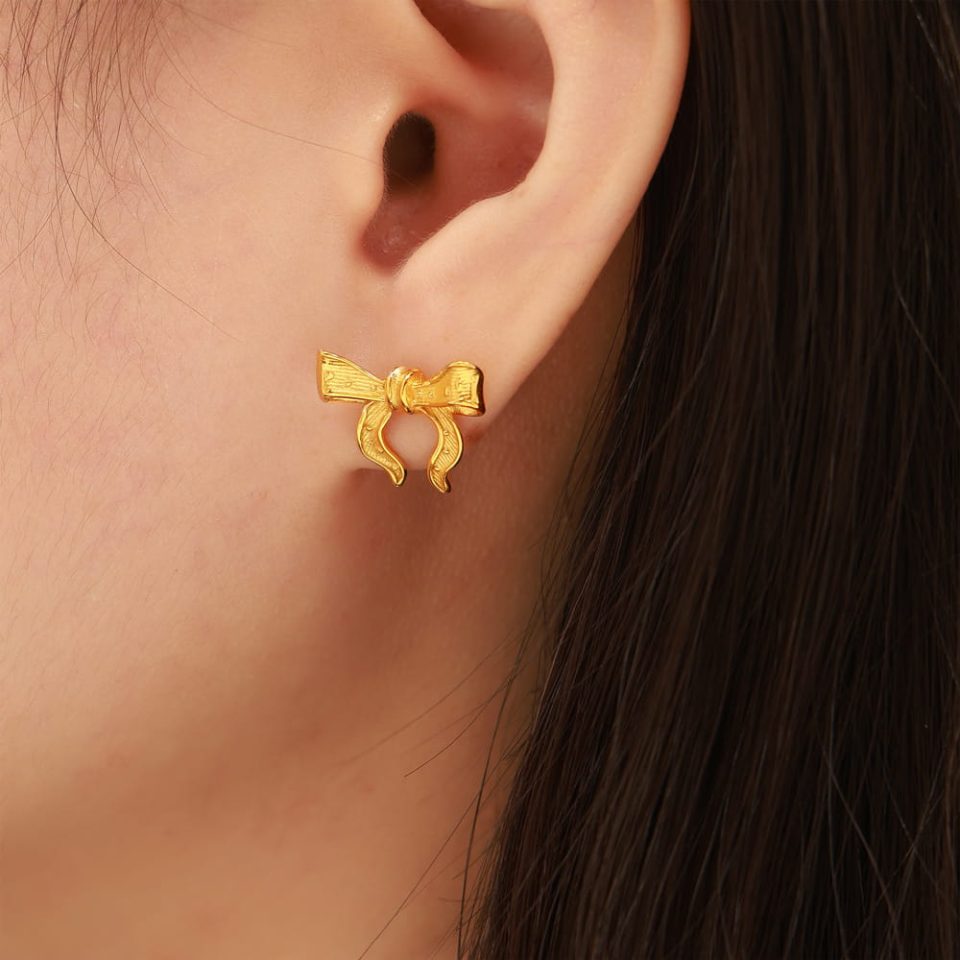 Model wearing gold geometric stainless steel dangle earrings – modern minimalist look