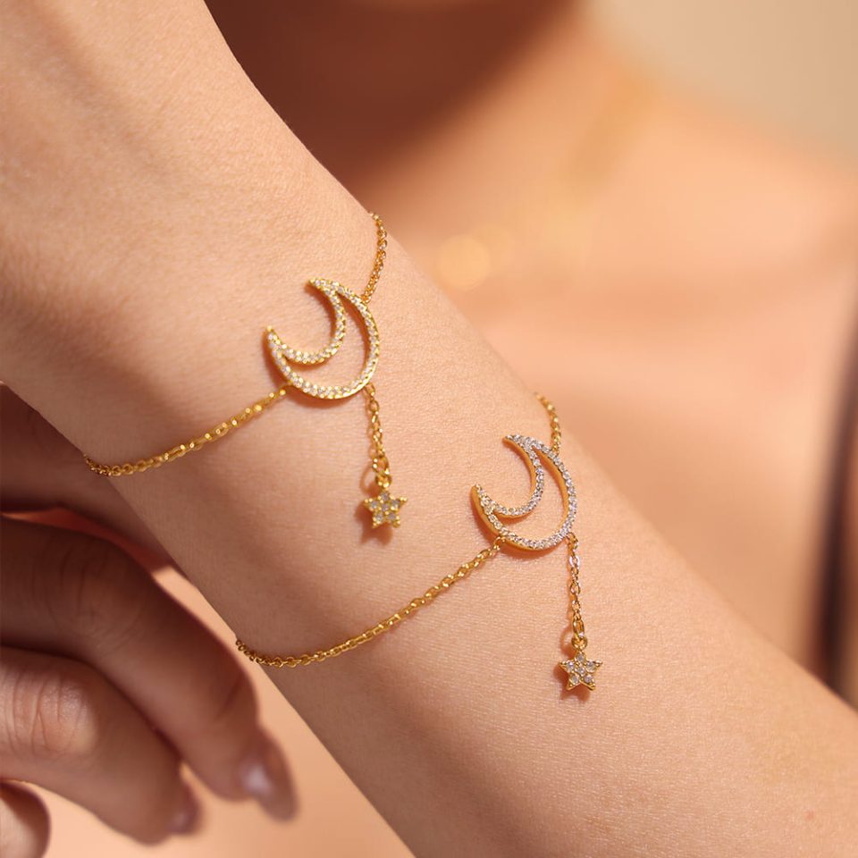 Model wearing gold celestial moon and star cubic zirconia tennis bracelet
