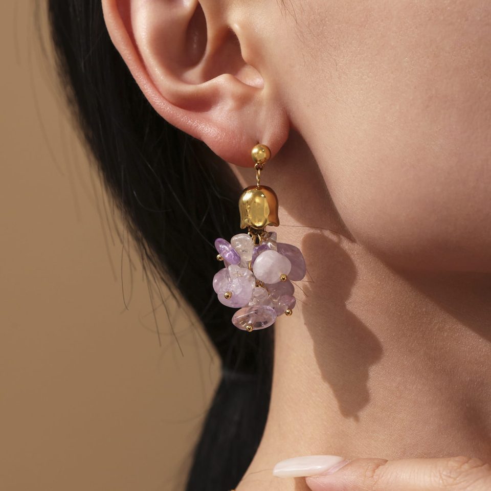 Model Wearing Purple Tassel Earrings with Layered Necklaces and Bracelets
