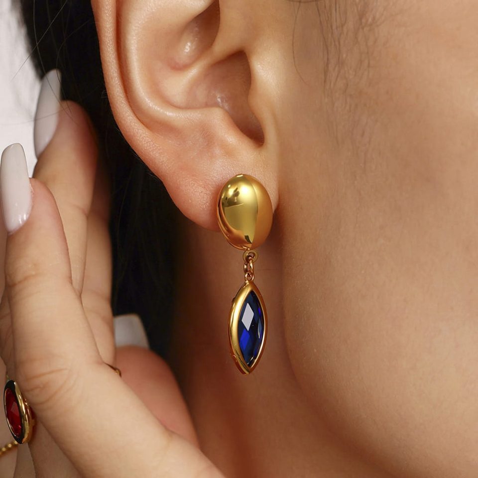 Model wearing gold blue glass stone earrings txf280