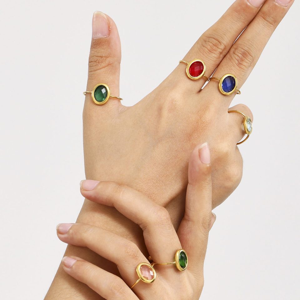 Model wearing oval glass stone ring TXA278