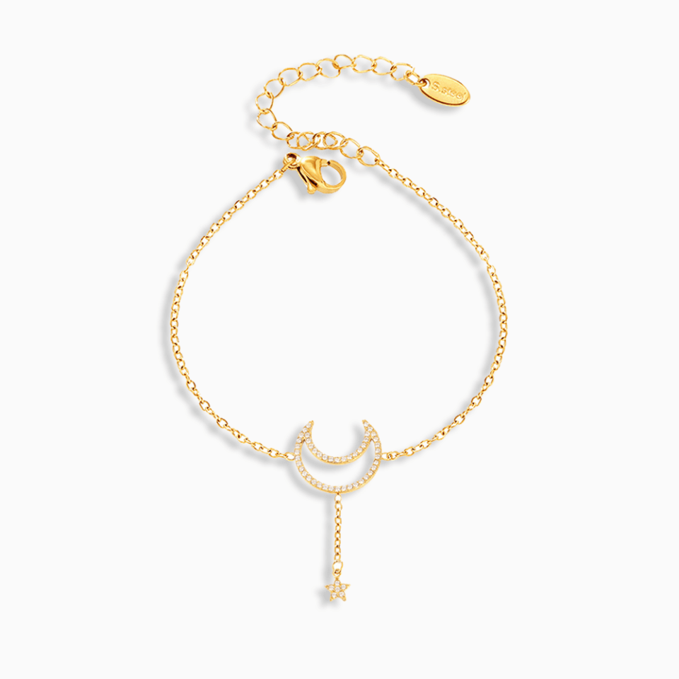 Gold stainless steel tennis bracelet with moon and star design featuring cubic zirconia
