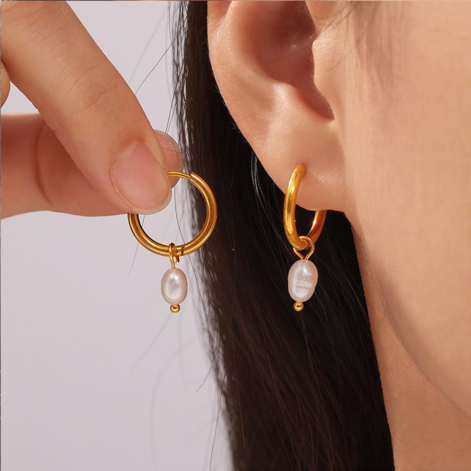 Model wearing Gold Shell Pearl Earrings | Geometric Freshwater Pearl Hoops, elegant and waterproof pearl earrings for everyday wear
