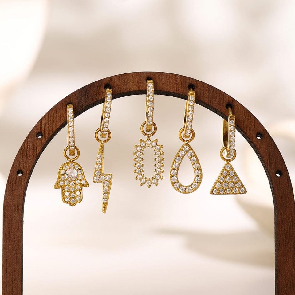 Warm-toned gold oval zircon earrings on display – minimalist fashion jewelry