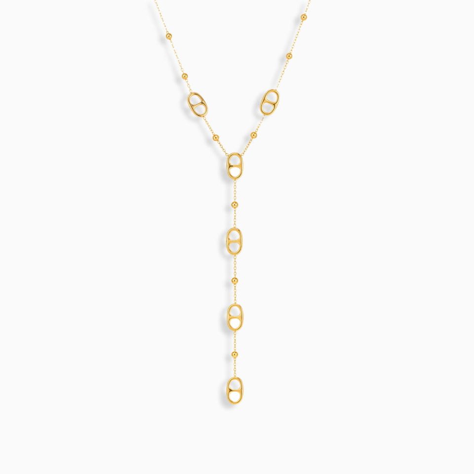 Woman wearing a gold stainless steel lariat necklace with layered Y-chains