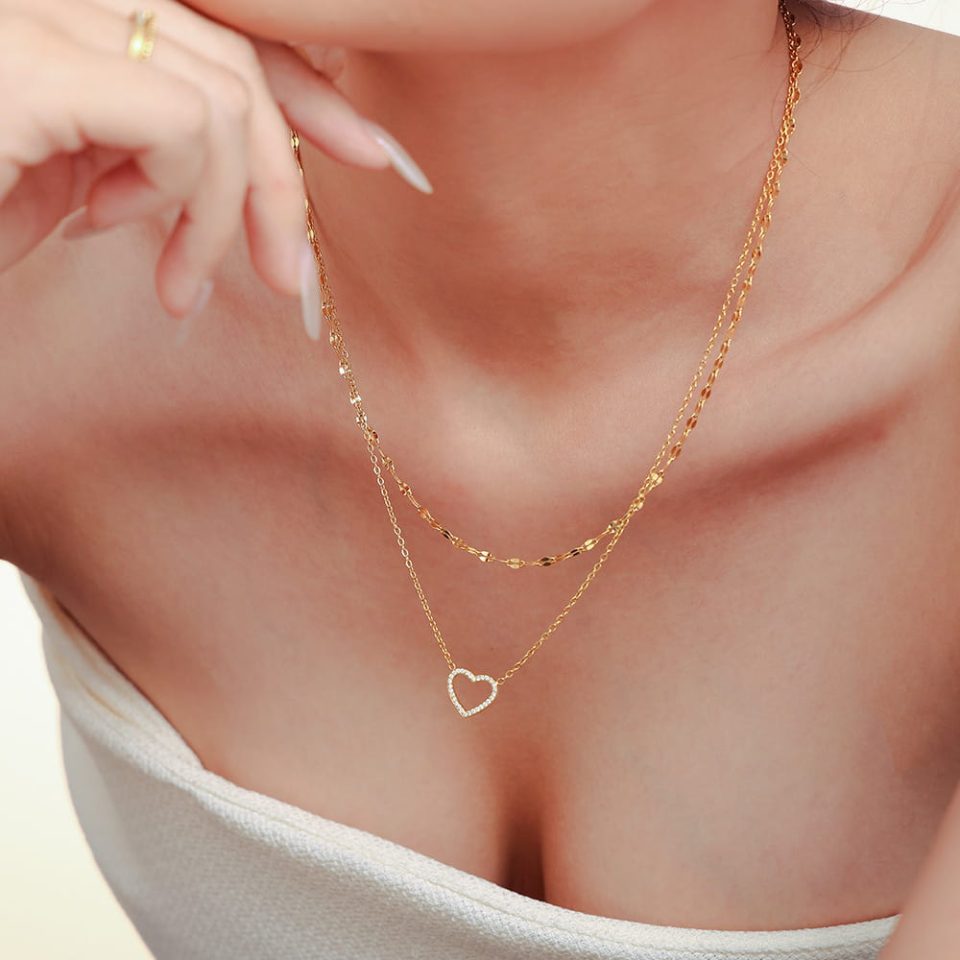 Model wearing the Layered Pendant Heart Necklace in gold with CZ heart pendant.