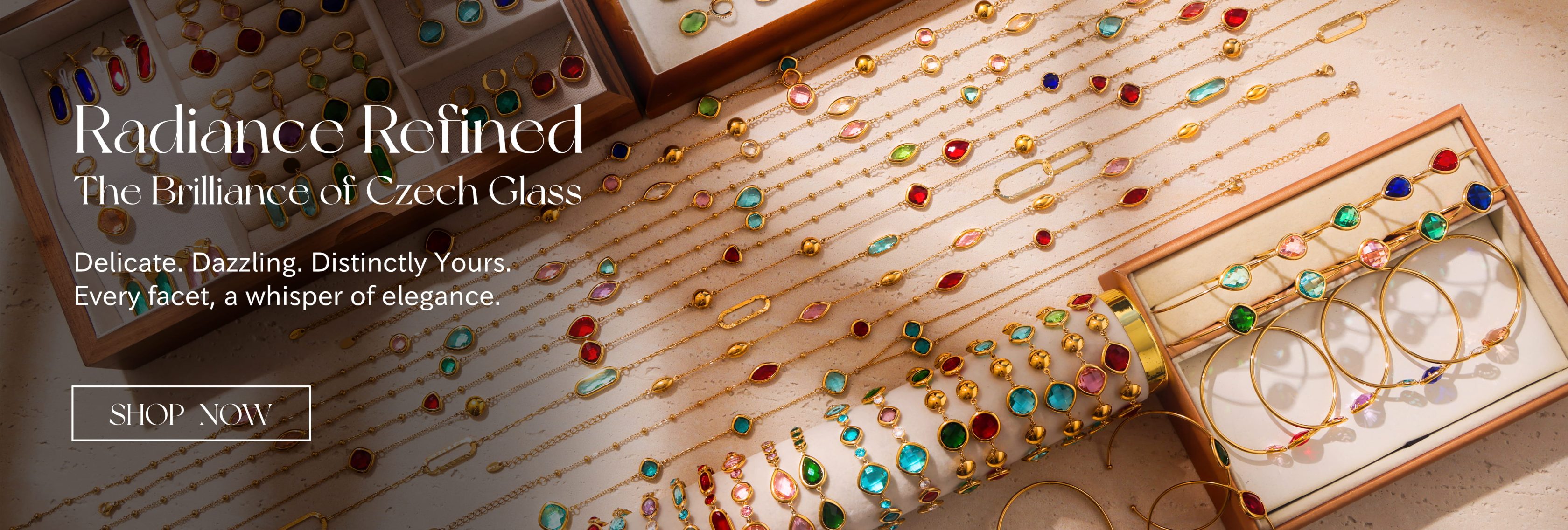Gold jewelry sets with colorful Czech glass gemstones displayed in trays and boxes