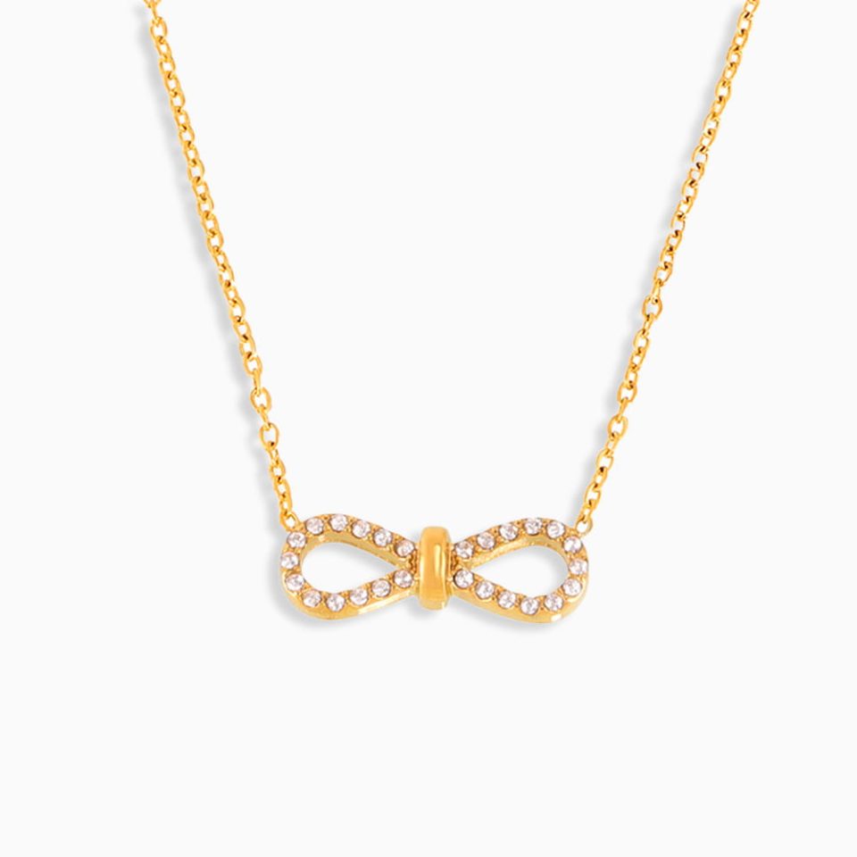 Gold infinity bow layered chain necklace with cubic zirconia on white background