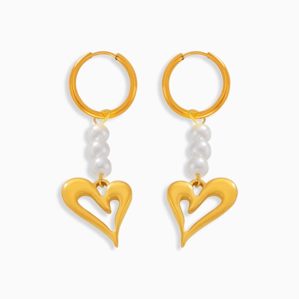A pair of golden heart hoop earrings in 18K plated stainless steel on a white background