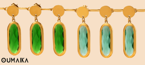 Emerald green sea glass hoop earrings hanging from driftwood