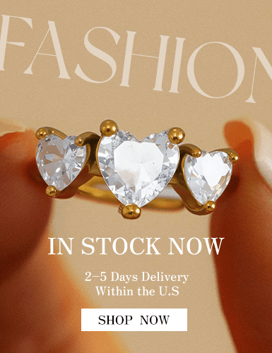 Gold stainless steel ring with three heart-shaped cubic zirconia stones held by hand