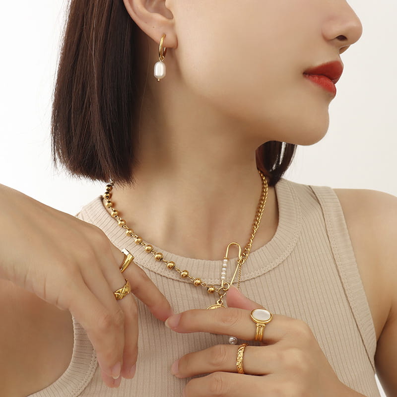 Model wearing Fleur Circle Pearl Earrings in gold – elegant freshwater pearl hoops