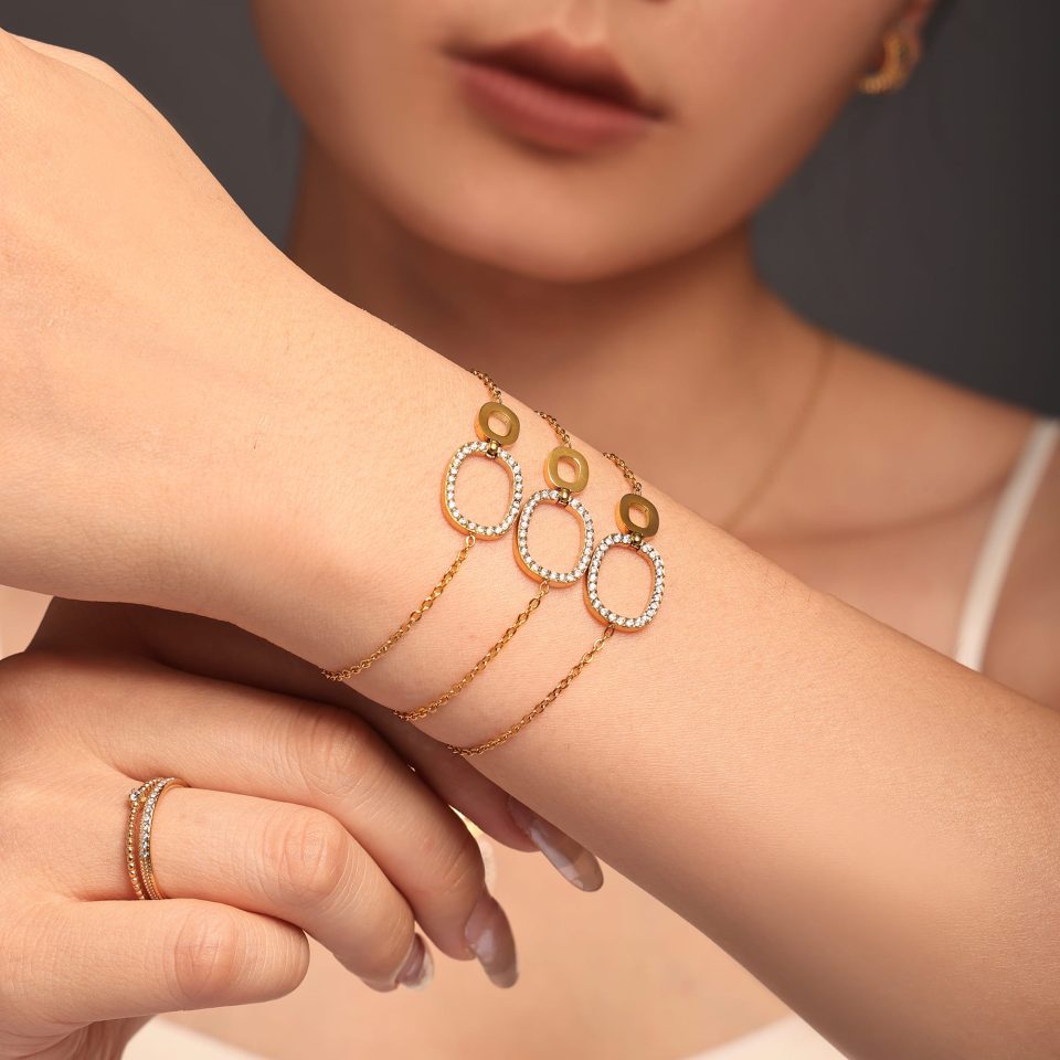 Model wearing the gold CZ duo circle tennis bracelet in a minimalist outfit.