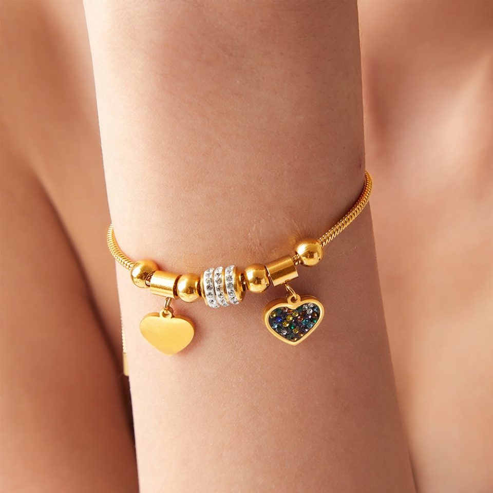 Model showing extended arm with Gothic Heart CZ Bracelet in gold finish