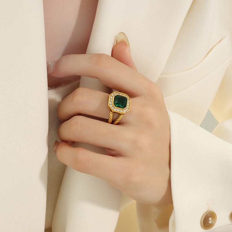 Model wearing green geometric statement ring on hand with gold stainless steel band